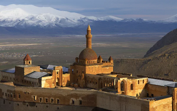 HD desktop wallpaper showcasing the man-made Ishak Pasha Palace with detailed architecture against a backdrop of vast plains and snow-capped mountains.