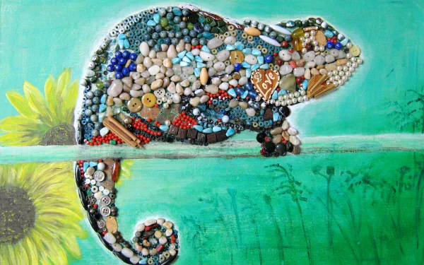 Artistic HD desktop wallpaper featuring a chameleon crafted from colorful buttons, beads, and small objects against a soft teal background with a sunflower detail.