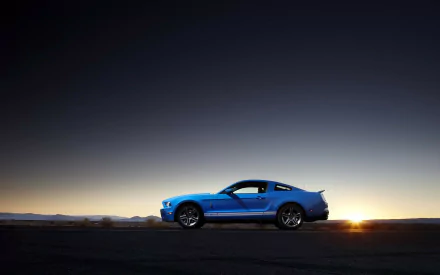 Blue Ford Mustang Shelby Cobra GT 500 in profile on an open road at sunset, HD PC desktop wallpaper background.