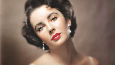 A stunning HD close-up of actress Elizabeth Taylor, showcasing her iconic beauty with elegant earrings, soft curls, and striking blue eyes against a muted background.