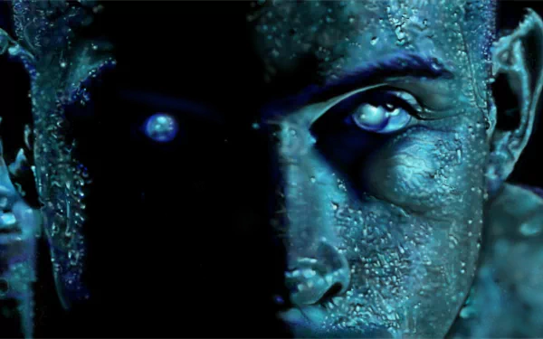 Close-up of Riddick's frost-covered face with glowing eyes in blue light — 2K Quad HD PC desktop wallpaper from the Riddick movie.