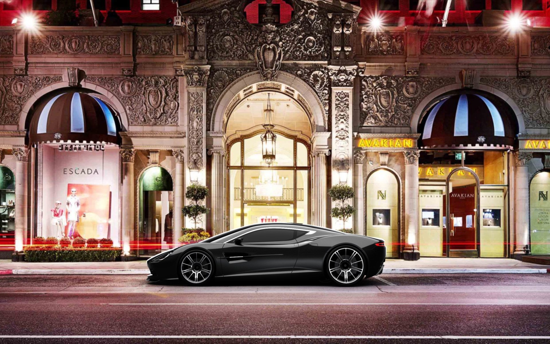HD PC desktop wallpaper featuring a sleek black Aston Martin DBC parked in front of an ornate, illuminated urban building at night.