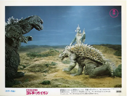 HD PC desktop wallpaper from the movie Godzilla vs. Gigan featuring Godzilla facing off against Gigan and Anguirus in a rugged landscape.