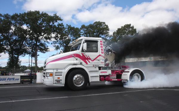 4K Ultra HD PC desktop wallpaper of a white and pink Scania truck emitting thick black smoke, set against a backdrop of trees and a partly cloudy sky.