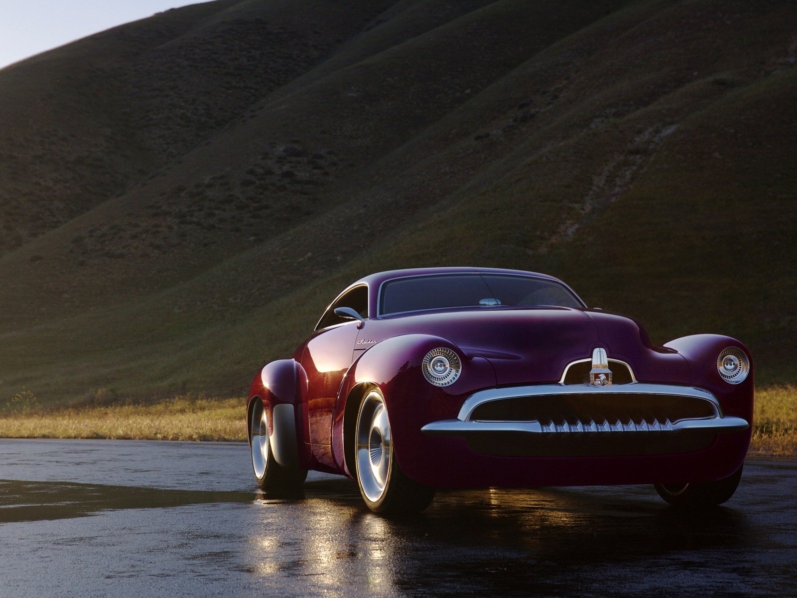 A sleek maroon Holden Efijy vehicle parked on a wet road with hills in the background, featured as an HD PC desktop wallpaper and background.
