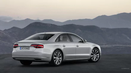 A sleek Audi A8 parked against a scenic backdrop of mountains, showcasing its elegant design and luxurious features. This HD desktop wallpaper captures automotive sophistication.