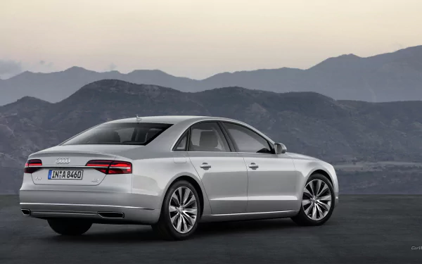 A sleek Audi A8 parked against a scenic backdrop of mountains, showcasing its elegant design and luxurious features. This HD desktop wallpaper captures automotive sophistication.
