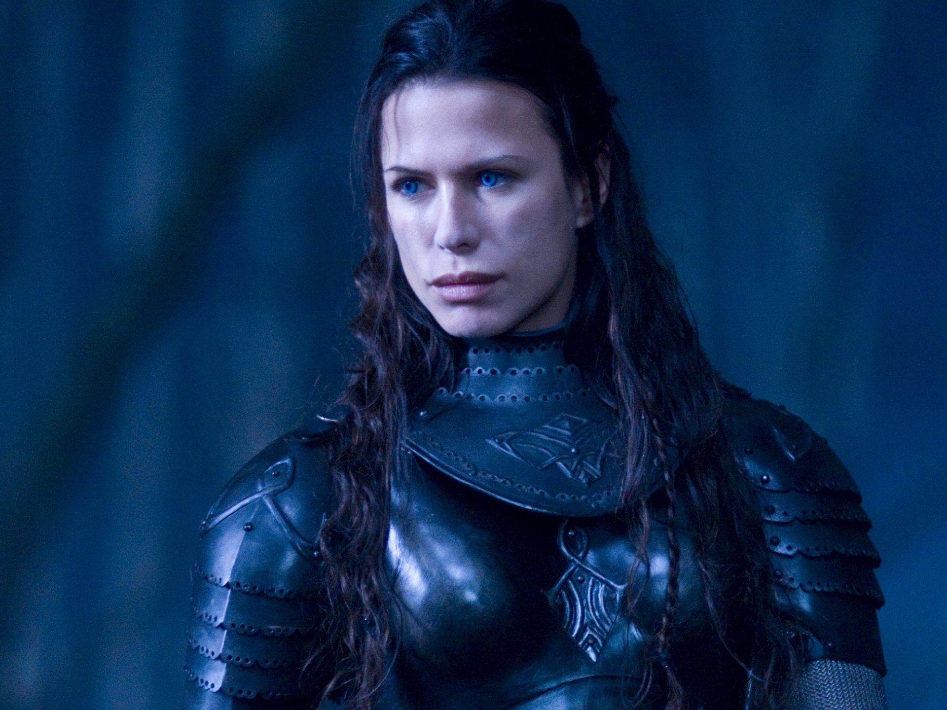 HD PC desktop wallpaper featuring a close-up of a character from the movie Underworld: Rise of the Lycans in dark armor with intense blue lighting.