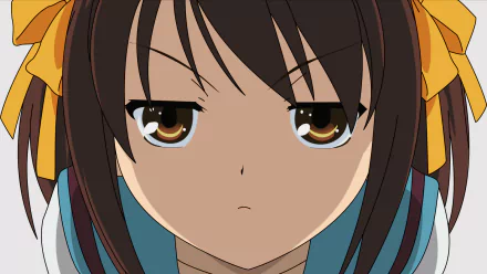 Close-up of Haruhi Suzumiya from The Melancholy of Haruhi Suzumiya anime, featured as an HD PC desktop wallpaper with her determined expression and signature yellow ribbons.