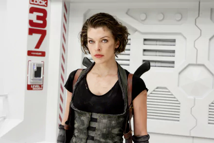Milla Jovovich in a dramatic pose from Resident Evil: Afterlife, set against a futuristic backdrop. This HD wallpaper captures her fierce character in the film.