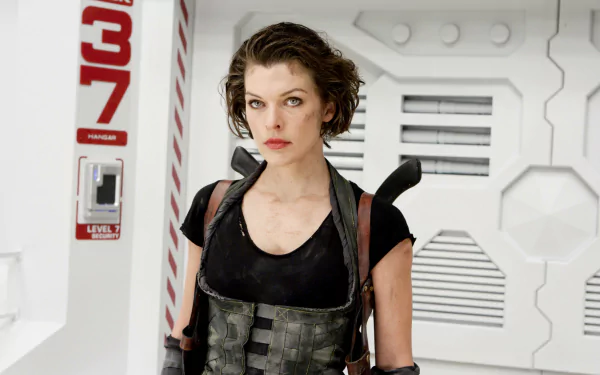 Milla Jovovich in a dramatic pose from Resident Evil: Afterlife, set against a futuristic backdrop. This HD wallpaper captures her fierce character in the film.
