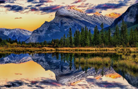 Vibrant sunset over Mount Rundle and Vermilion Lakes reflecting in the calm waters of Banff National Park, Alberta, Canada.