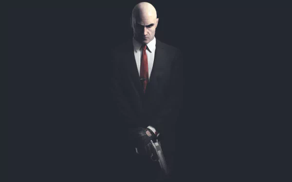 A dramatic HD PC desktop wallpaper featuring a bald assassin in a suit, inspired by the video game Hitman, exuding an aura of mystery and intensity.