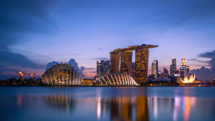 A stunning HD view of Singapore's Marina Bay Sands at twilight, showcasing the city's iconic skyline and vibrant architecture reflecting on the water.