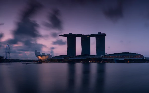 Marina Bay Sands at dusk reflected on calm water in Singapore — 4K Ultra HD PC desktop wallpaper showcasing the man-made waterfront skyline.