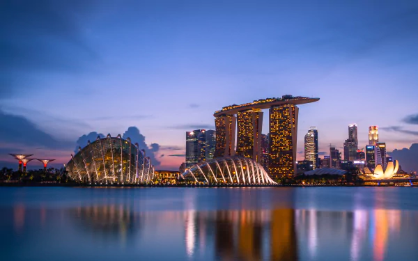 A stunning HD view of Singapore's Marina Bay Sands at twilight, showcasing the city's iconic skyline and vibrant architecture reflecting on the water.