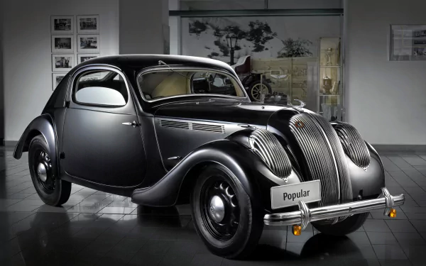 HD PC desktop wallpaper featuring a classic Skoda vehicle in a sleek black finish, displayed in an elegant indoor setting.