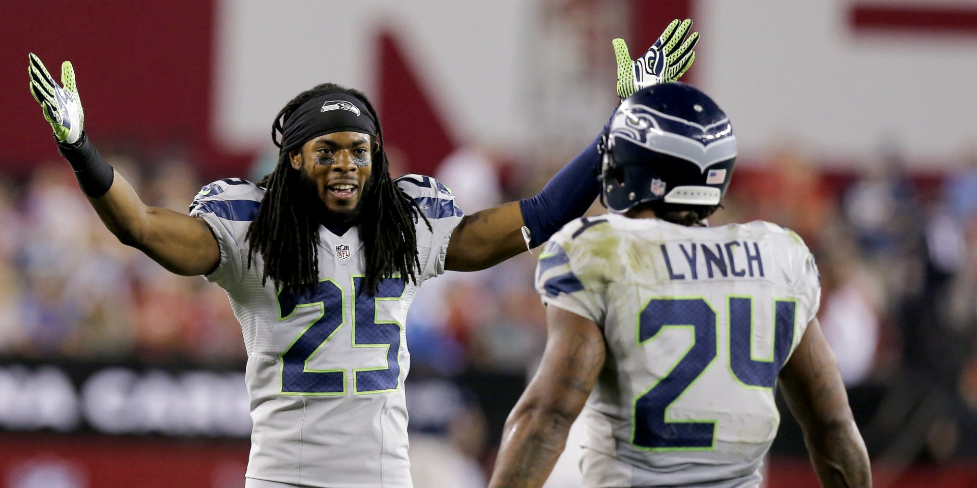 HD desktop wallpaper featuring Seattle Seahawks players Marshawn Lynch (#24) and Richard Sherman (#25) in action during a football game.