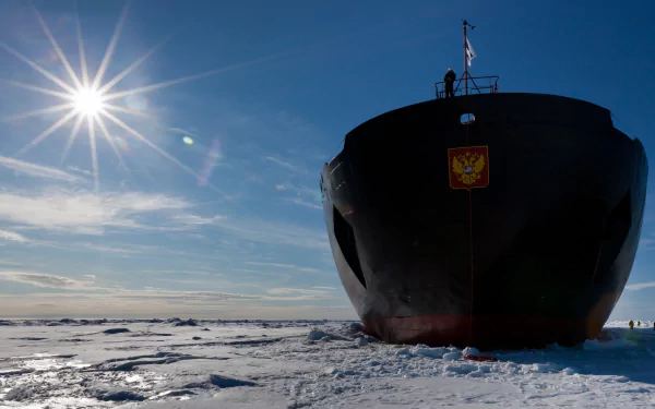 2K Quad HD PC desktop wallpaper showing an icebreaker ship/vehicle cutting through frozen sea ice beneath a bright sun.