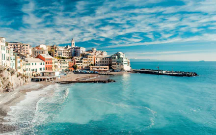 A stunning view of Genoa's coastline in Cinque Terre, showcasing vibrant man-made buildings against a backdrop of serene blue waters and a clear sky in Liguria, Italy.