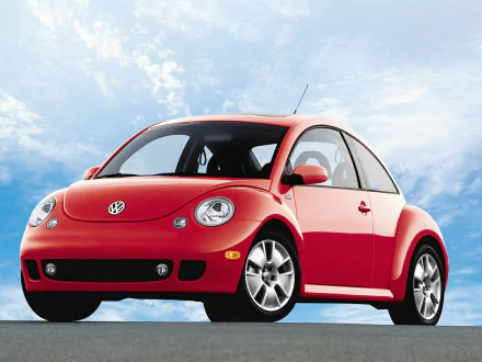 Red Volkswagen Beetle parked under a bright blue sky, showcased as an HD PC desktop wallpaper and background.