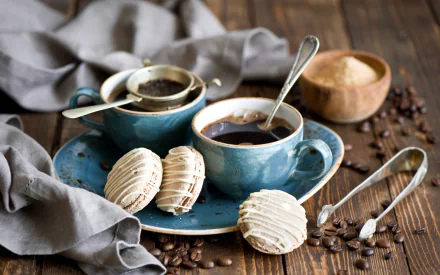HD desktop wallpaper featuring a coffee cup, biscuits on a blue plate, and a wooden bowl of sugar on a rustic wooden table with a gray cloth.