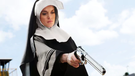 Actress in a nun's habit aiming a revolver against a bright sky, cinematic still from the movie Machete — 5K Ultra HD PC desktop wallpaper/background.
