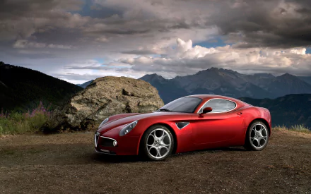 Red Alfa Romeo 8C Competizione sports car on a mountain overlook under dramatic clouds — HD PC desktop wallpaper background featuring an Alfa Romeo vehicle.