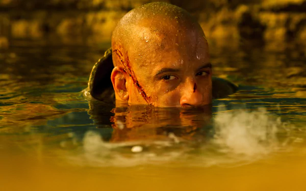 Vin Diesel as Riddick emerges from water, showcasing an intense moment from the movie. This striking 4K Ultra HD wallpaper captures the character's gritty atmosphere.