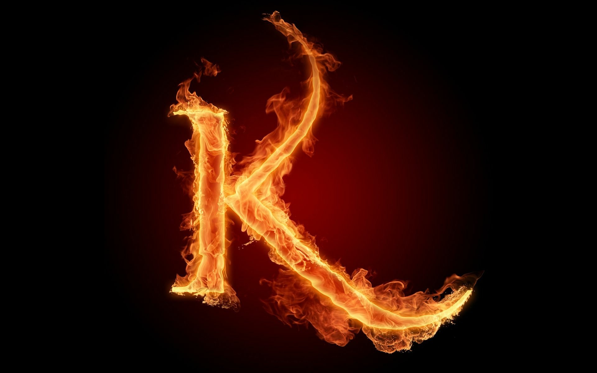 Artistic HD PC desktop wallpaper featuring a bold letter K engulfed in dynamic, vivid flames against a dark background.