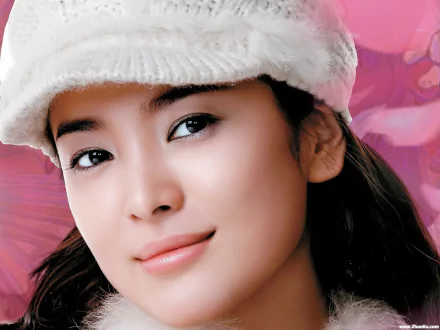 HD wallpaper featuring Song Hye Kyo, a popular Korean celebrity, with a soft expression against a vibrant pink background.