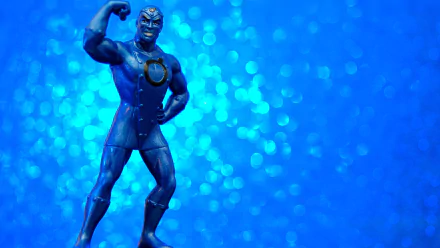 DC Comics Metal Men figure in heroic pose on a blue bokeh field — 2K Quad HD PC desktop wallpaper, comic book style background.