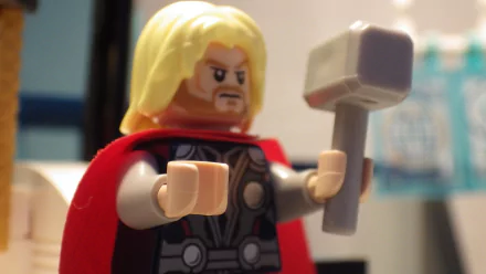 HD desktop wallpaper featuring a Lego version of Thor from the video game Lego Marvel Super Heroes, showcasing the character with his iconic hammer and red cape.