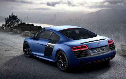 A stunning blue Audi R8 V10 Plus parked on a scenic overlook, showcasing its sleek design and performance credentials against a dramatic backdrop. Perfect HD wallpaper for car enthusiasts.
