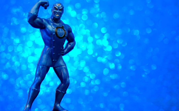 DC Comics Metal Men figure in heroic pose on a blue bokeh field — 2K Quad HD PC desktop wallpaper, comic book style background.