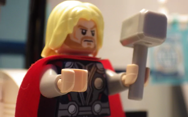 HD desktop wallpaper featuring a Lego version of Thor from the video game Lego Marvel Super Heroes, showcasing the character with his iconic hammer and red cape.