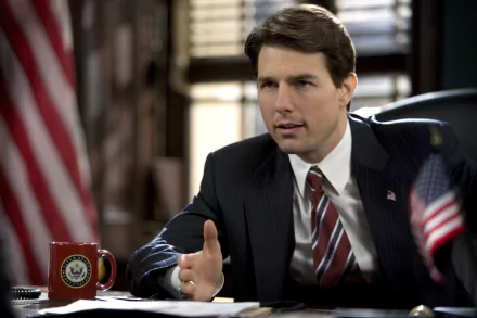 HD PC desktop wallpaper featuring a scene from the movie Lions for Lambs, showing a man in a suit speaking at a desk with American flags nearby.