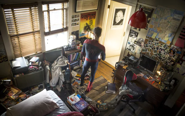 HD desktop wallpaper from The Amazing Spider-Man 2 movie, featuring Spider-Man standing in a cluttered room filled with posters, books, and photos.