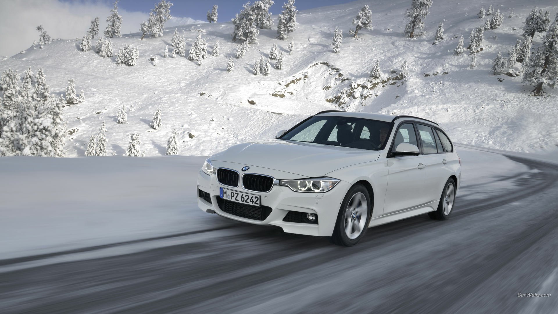 2013 BMW 320d driving on a snowy road, showcased as an HD PC desktop wallpaper and background.