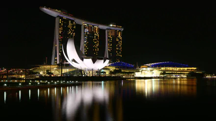 Night view of the iconic Marina Bay Sands in Singapore, beautifully illuminated and reflected on the water, captured in stunning 4K Ultra HD for a desktop wallpaper.