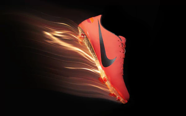 A vibrant Nike shoe appears to be in motion, surrounded by a dynamic burst of energy, set against a sleek black background. This creates an impactful HD desktop wallpaper.