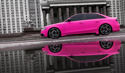 A striking pink Audi A4 is showcased in this HD desktop wallpaper, its vibrant color reflected in a water pool against an urban backdrop.