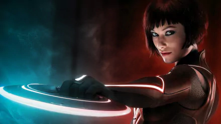 HD desktop wallpaper featuring Olivia Wilde as Quorra from TRON: Legacy, with glowing futuristic suit and disc in a dark, cybernetic environment.