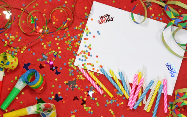 A vibrant birthday scene featuring colorful confetti, festive candles, and a blank card adorned with “Happy Birthday” text, set against a bright red background.