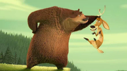 HD desktop wallpaper from Open Season (2006) movie showing a bear holding a startled deer by the antler in a forest setting.
