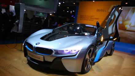 HD wallpaper of a sleek BMW i8, showcasing its futuristic design with scissor doors open, set as a background image.