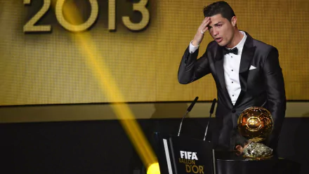 Cristiano Ronaldo expresses emotion at the 2013 FIFA Ballon d'Or ceremony, showcasing his achievements in sports. This HD image makes for an impactful desktop wallpaper.