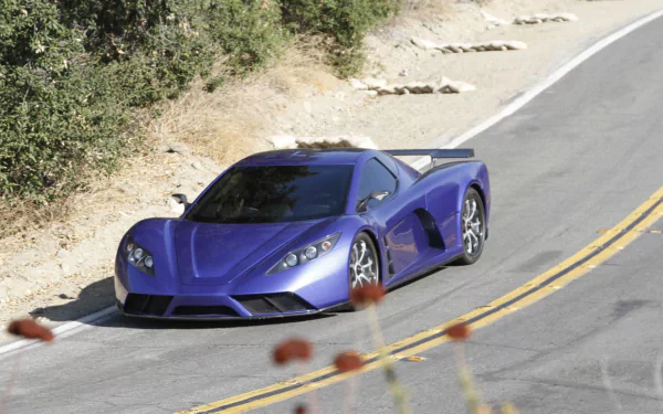 A sleek blue Kepler Motion vehicle driving on a winding road, captured in HD quality as a desktop wallpaper and background.