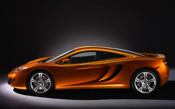 Orange McLaren MP4-12C supercar shown in profile against a dark background, featured as an HD PC desktop wallpaper and background.