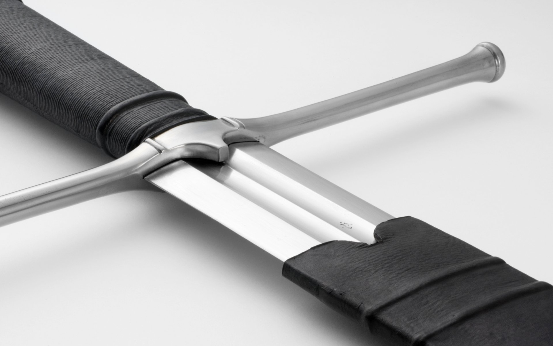 Close-up of a man-made sword with a leather-wrapped handle, displayed as an HD PC desktop wallpaper and background.